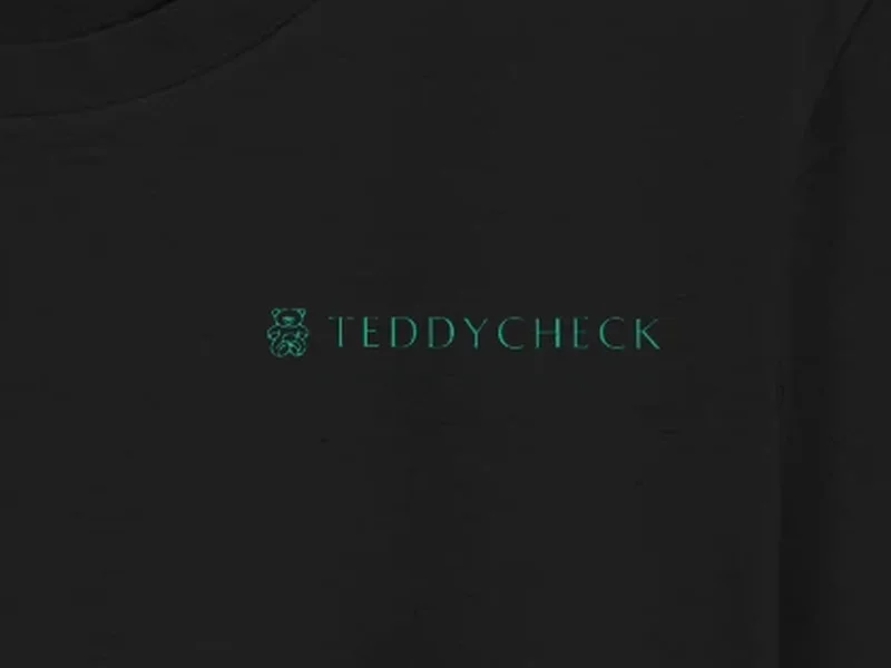 Close-up: TeddyCheck Black Tee, logo on the fabric